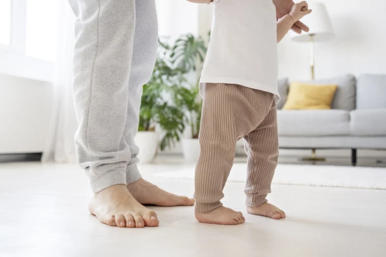 parent helping ivf baby walk (baby steps, baby feet)